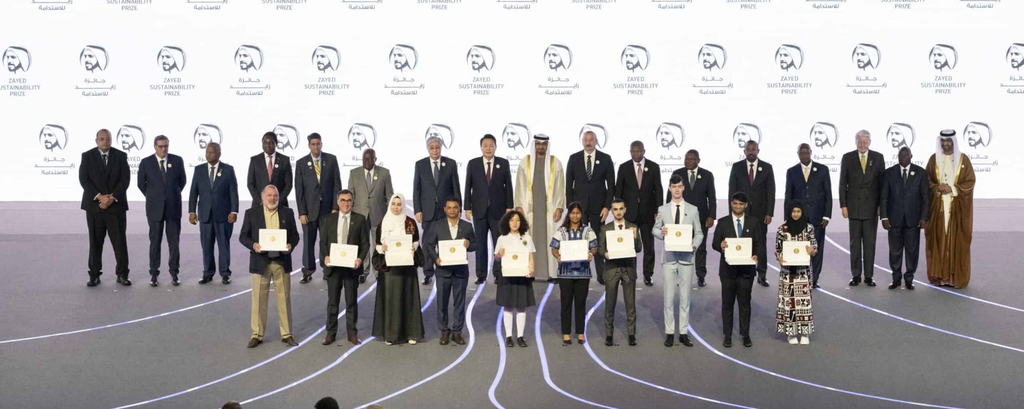 ABU DHABI, UNITED ARAB EMIRATES - January 16, 2023: (back row L-R) HE Siaosi Sovaleni, Prime Minister of Tonga, HE Aziz Akhannouch, Prime Minister of Morocco, HE Wavil Ramkalawan, President of Seychelles, HE Hakainde Hichilema, President of Zambia, HE Surangel Whipps Jr, President of Palau, HE Nana Akufo-Addo, President of Ghana, HE Kasim-Jomart Tokayev, President of Kazakhstan, HE Yoon Suk Yeol, President of South Korea, HH Sheikh Mohamed bin Zayed Al Nahyan, President of the United Arab Emirates, HE Ilham Aliyev, President of Azerbaijan, HE Joao Lourenco, President of Angola, HE Filipe Nyusi, President of Mozambique, HE Abiy Ahmed, Prime Minister of Ethiopia, HE Yoweri Museveni, President of Uganda, Olafur Ragnar Grimsson, former President of Iceland and Chairman of Arctic Circle, HE Tiemoko Meyliet Kone, Vice President of Ivory Coast, and HE Dr Sultan bin Ahmed Al Jaber, UAE Minister of Industry and Advanced Technology Group CEO of ADNOC and Chairman of Masdar, stand for a photograph with 2023 Zayed Sustainability Prize winners (front row) during the opening ceremony of Abu Dhabi Sustainability Week (ADSW 2023), at Abu Dhabi National Exhibition Centre (ADNEC).
( Mohamed Al Blooshi for the UAE Presidential Court )
---